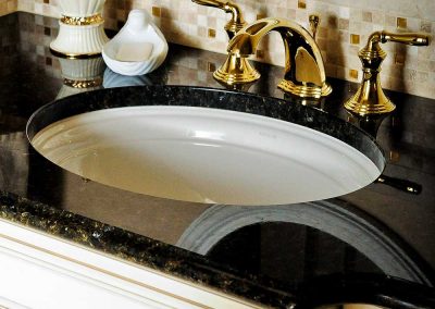 Traditional Powder Bath with Gold Faucet and Black Sleek Counter and White Cabinets