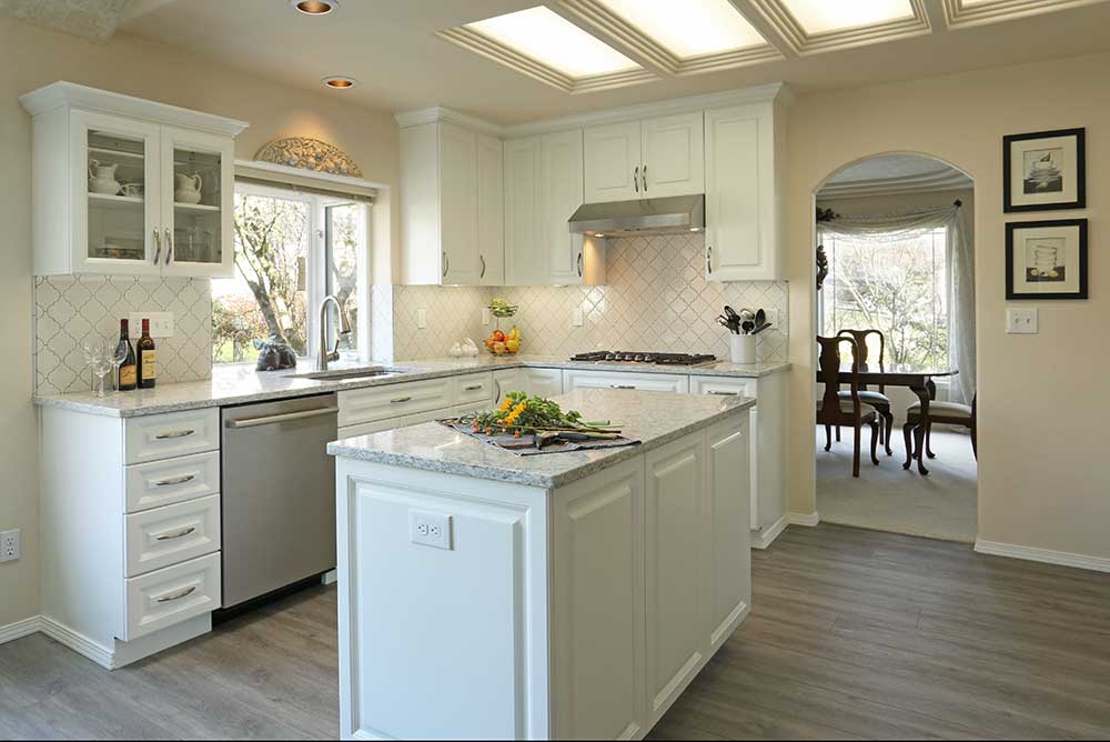 Traditional Kitchen with White and Egg Shell Colored Cabinets and Marble Island Counter in Gresham