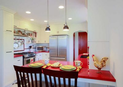 Portland Retro Design Kitchen with High Top Chairs at Ruby Red Countertop