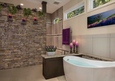 Master Bath Soaking Tub with Stone Slab Wall and Purple Accents