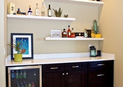 Basement Bar with Open Shelves for Liquor and Mini Fridge for Drinks