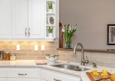 Contemporary Kitchen Sink with White Counter and Cabinets and Home Decorations