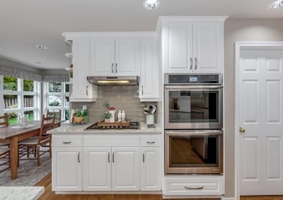 Contemporary Kitchen with White Cabinets Stove and Double Oven