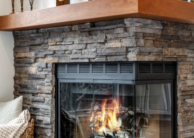 Contemporary Stone Fireplace with Wooden Mantel