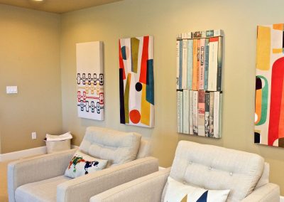 Abstract Art Prints with Two Arm Chairs in Basement