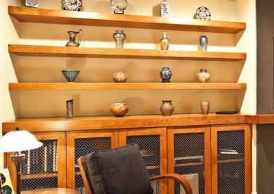 Reading Annex Home Addition with Full Open Shelving Pottery Vases and Reading Armchair