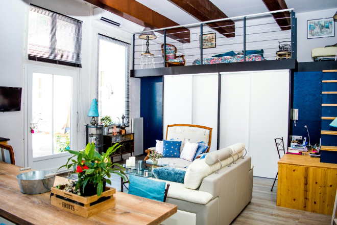 A-blue-open-concept-living-space-with-upper-and-lower-floors